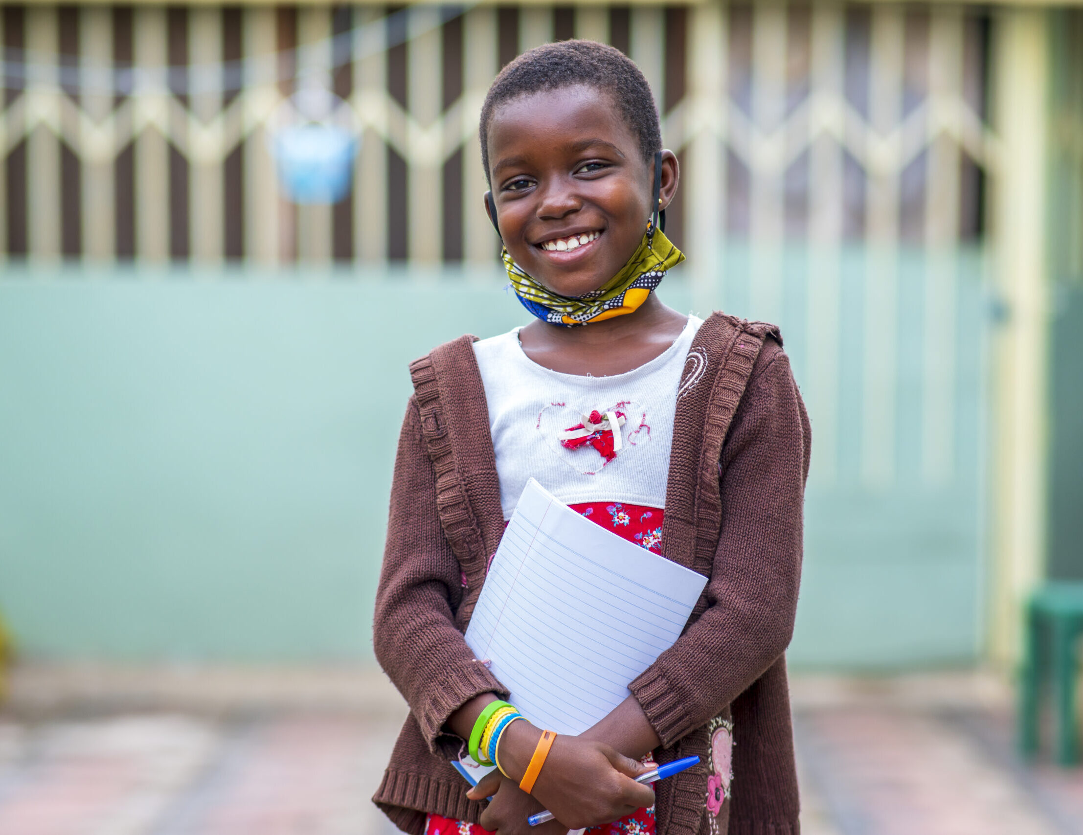 closeup shot black male child holding notebook education concept scaled e1745350082917